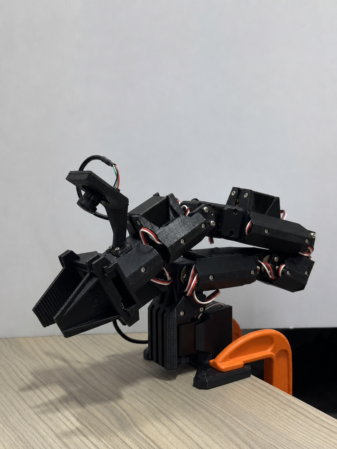 ElRobot arm folded, showing Feetech servos and wiring
