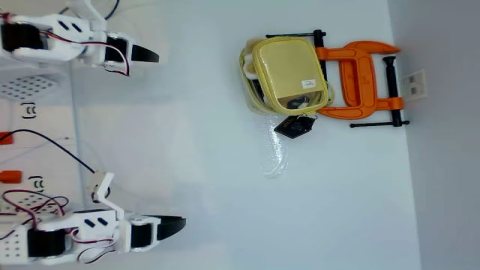 SO101 arms positioned to put away a toy