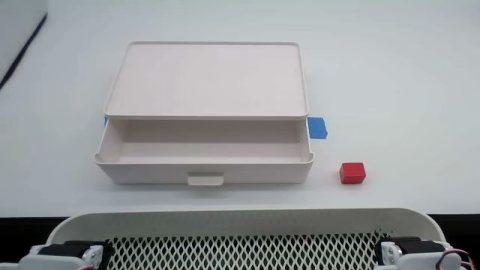 Red cube and open box prepared for a pick-and-place skill