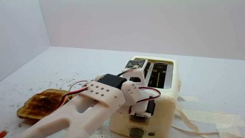 SO101 arm pressing a button on a toaster