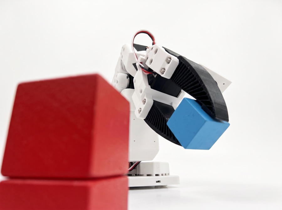SO-101 robot arm stacking blue and red cubes